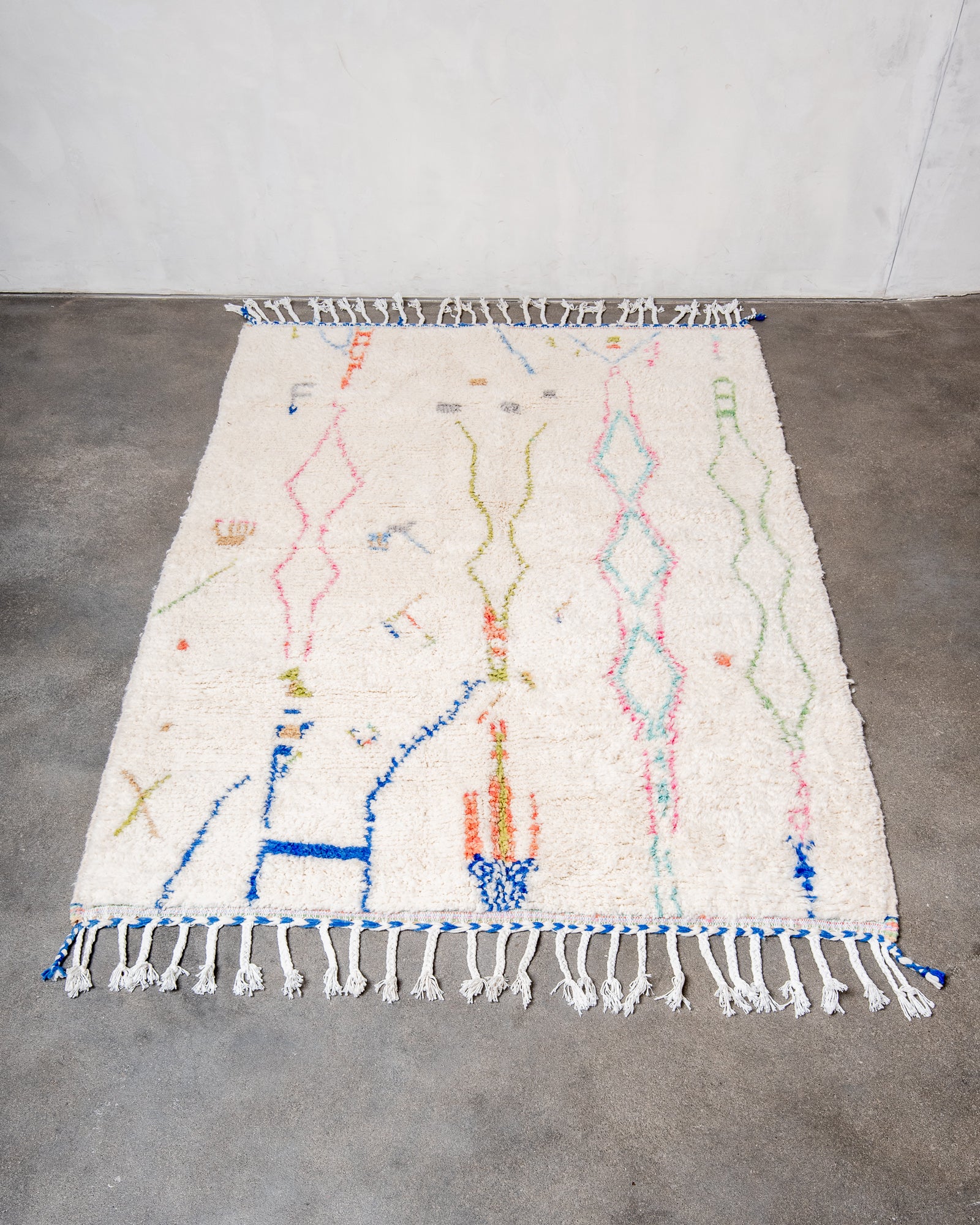 Modern, designer, handcrafted Berber rug from Morocco. Beniourain carpet with beautiful colours and patterns and fluffy wool texture.